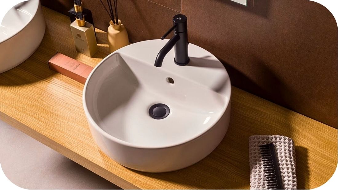 Okrugli nadgradni lavabo na drvenoj ploči u modernom kupatilu